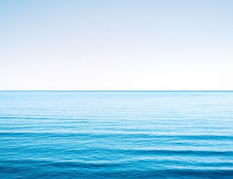 A body of water with a blue sky in the background.