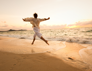 A person jumping on a beach.