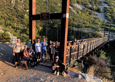 A group of people on a suspension bridge.
