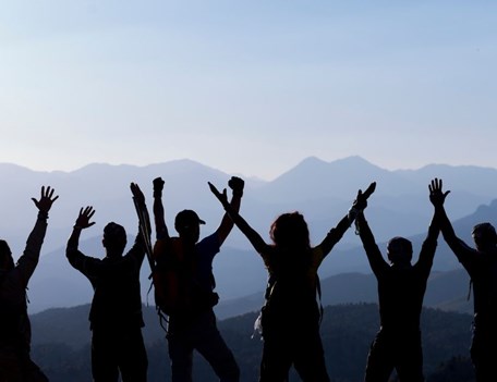 A group of people raising their hands.