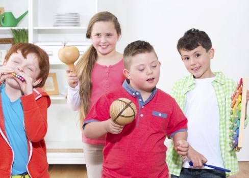 A group of kids holding a bowl.