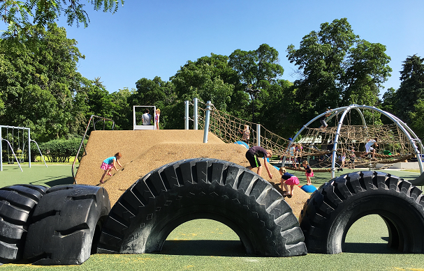 A playground with a jungle gym and tires